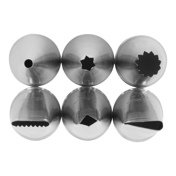 Six metal piping tips with different shaped openings are arranged in two rows, showing a variety of decorative patterns for cake or pastry decorating.