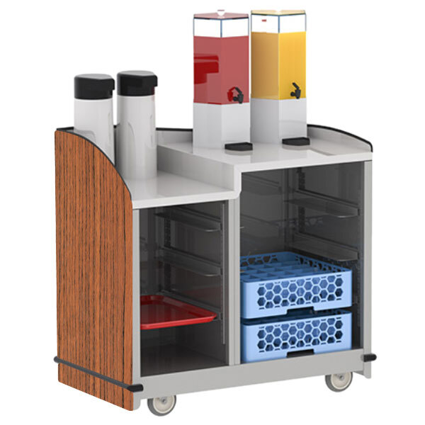 A Lakeside serving cart with a dual height top and Victorian cherry finish holding two trays and two containers of juice.