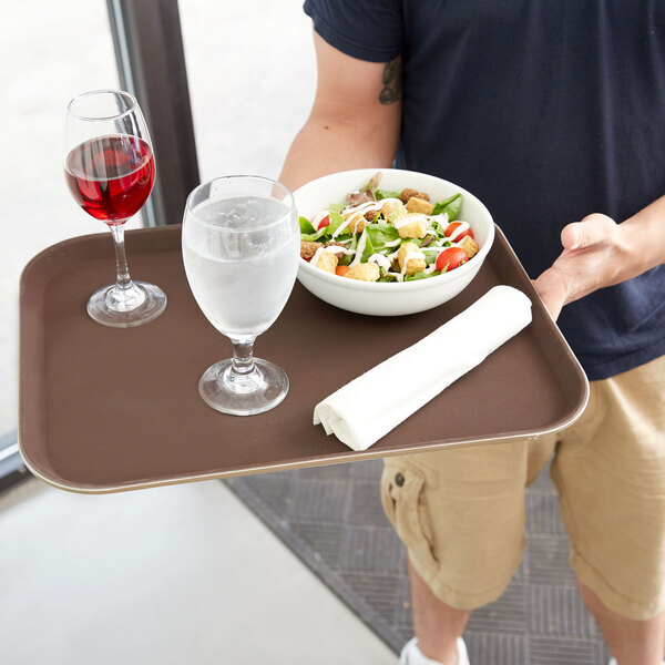 a glass of water and a bowl of salad