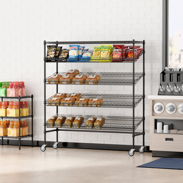 A Regency black wire mobile merchandising rack with shelves of food.