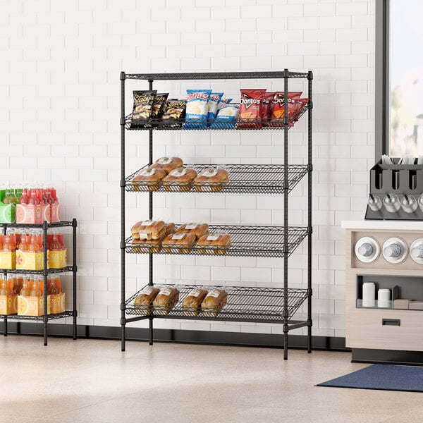 A black Regency wire shelving rack with food and snacks on the shelves.