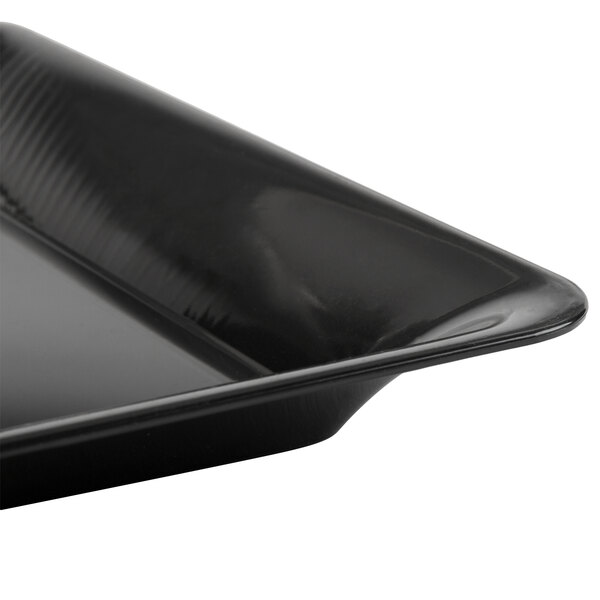 A close-up of a Fineline black plastic square catering tray.