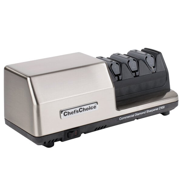 An Edgecraft Chef's Choice 2100 knife sharpener with three knives on it.