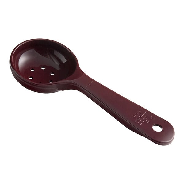A reddish brown Carlisle perforated portion spoon with a short handle.