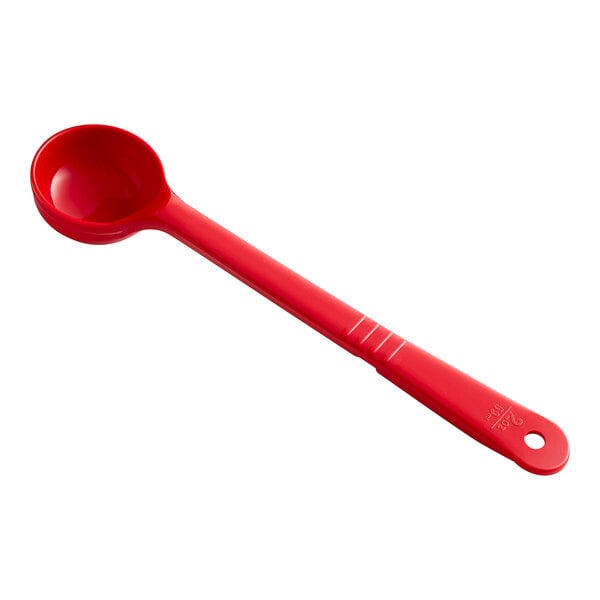 A red plastic Carlisle portion spoon with a long handle.
