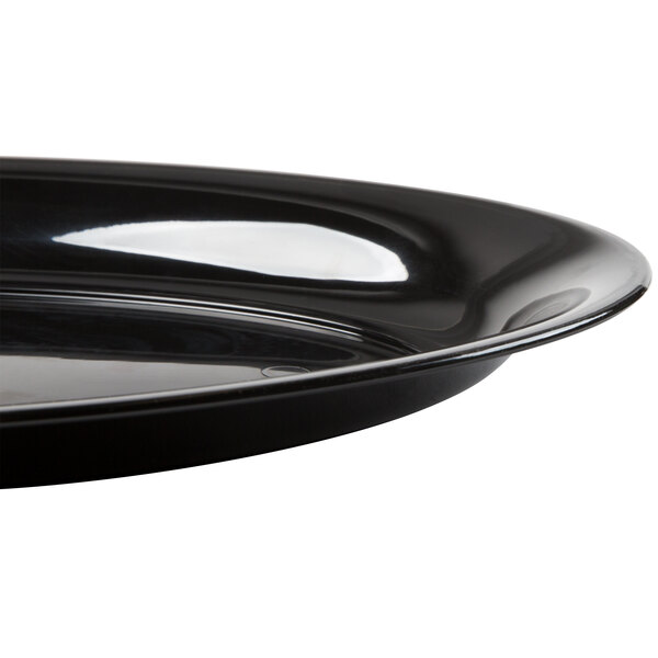 A close-up of a Fineline black plastic oval catering tray.
