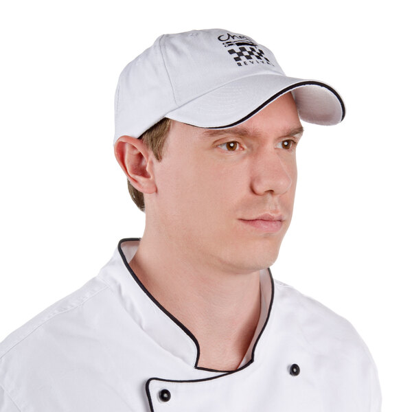 A man wearing a white Chef Revival baseball cap with black logo.