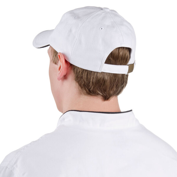 A man wearing a white Chef Revival baseball cap with a black logo.