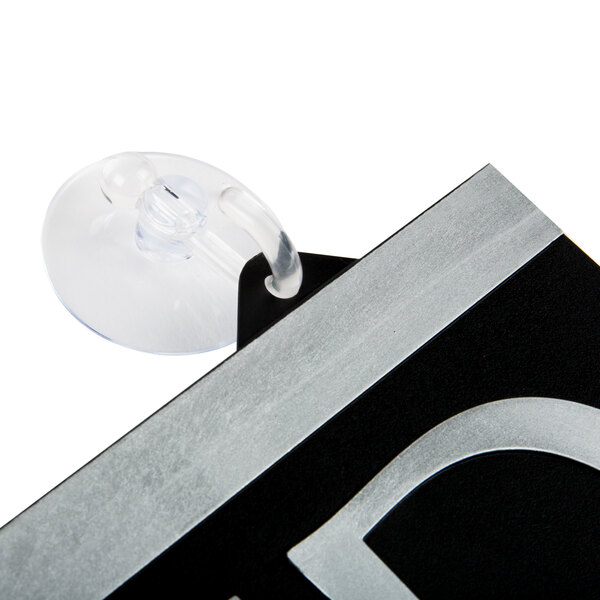 A Headline Sign Century Series black and white reversible sign with a suction cup attached to a black and silver frame.