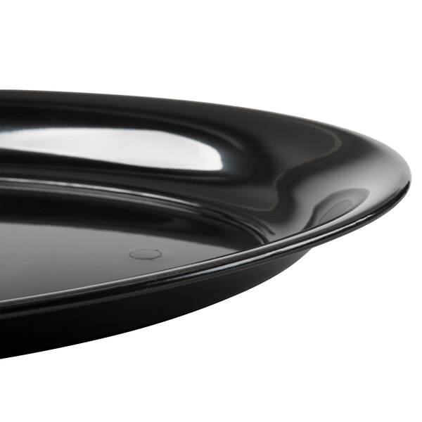 A close-up of a Fineline black plastic oval catering tray.