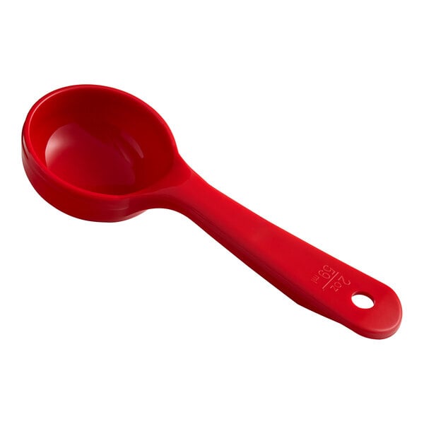 A red plastic Carlisle measuring spoon with a handle.