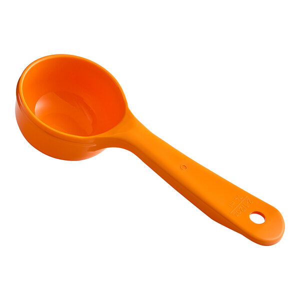 A Carlisle orange plastic measuring spoon.