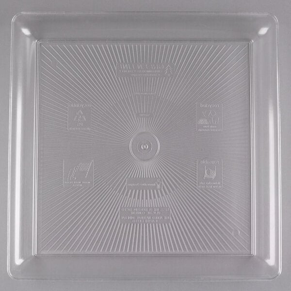 A clear plastic tray with lines and symbols.