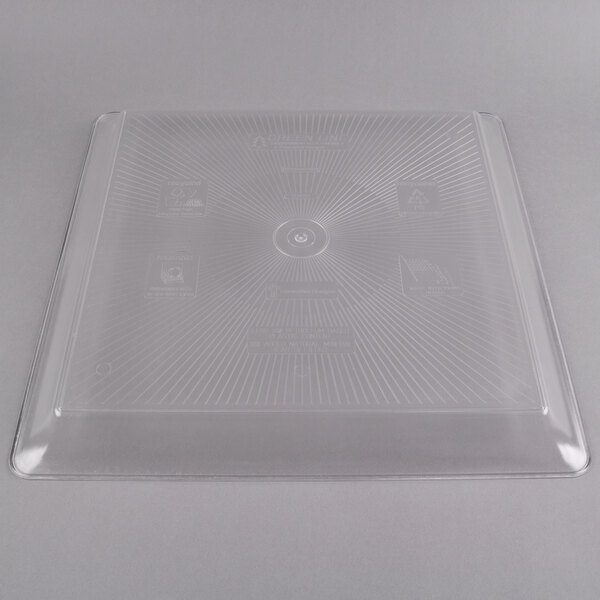 A clear plastic square catering tray with lines on it.