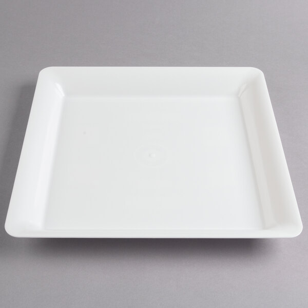 A white square Fineline catering tray with a clear lid on it.
