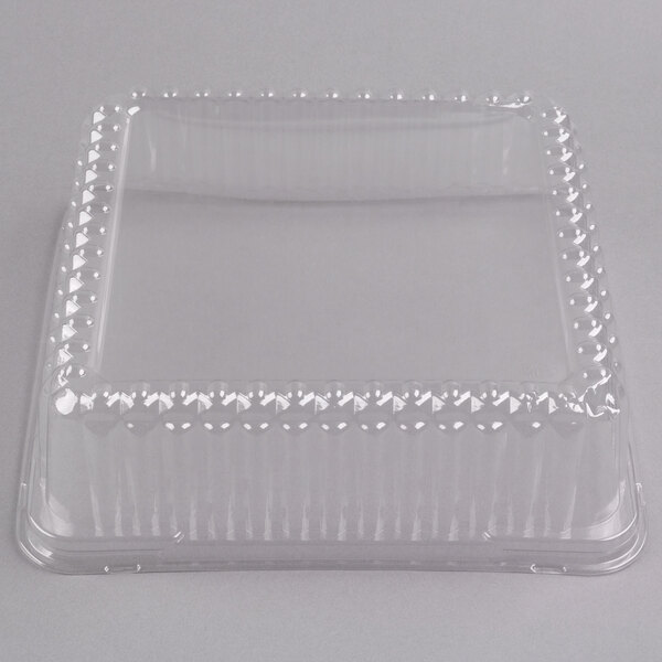 A clear plastic Fineline container with a clear plastic square dome lid.