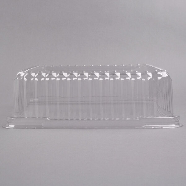 A close-up of a Fineline clear plastic square dome lid on a clear plastic container.