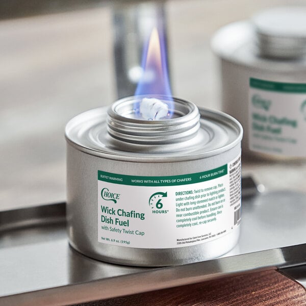A can of Choice 6 Hour Wick Chafing Dish Fuel with a visible flame and safety twist cap.