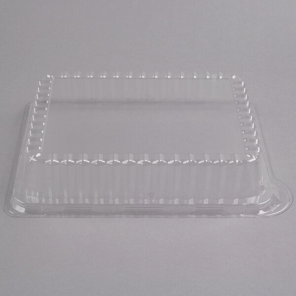 A clear plastic rectangular lid on a white background.