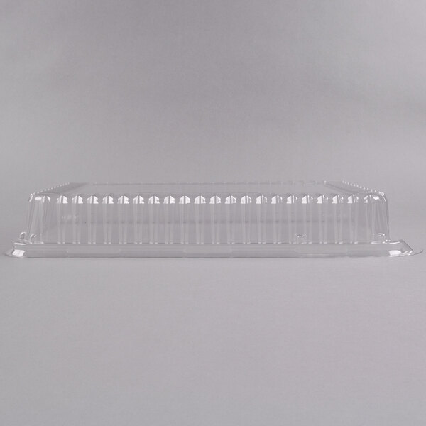A Fineline clear plastic rectangular dome lid on a clear plastic container.