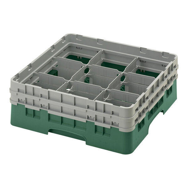 A green and grey plastic Cambro glass rack with nine compartments.