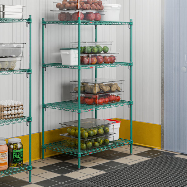 A green four-shelf wire stationary shelving unit used for storage in a commercial or kitchen setting.