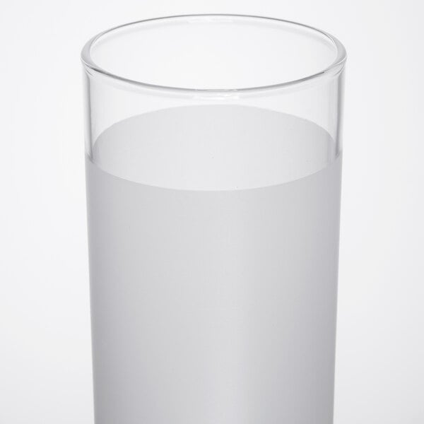 A close-up of a Libbey frosted clear lip zombie glass filled with water.