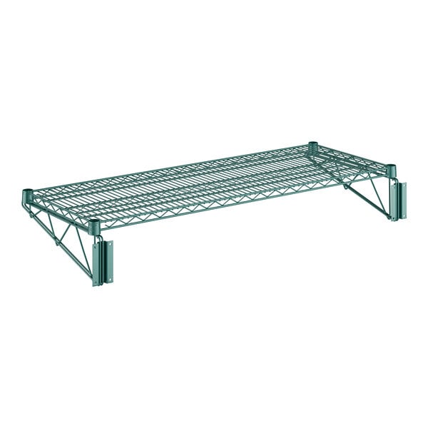 A close-up of a Regency green metal wire wall mount shelf with two metal supports.