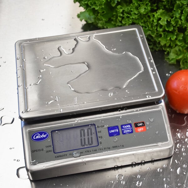 A Globe GPS10-S digital portion scale with water droplets on it.