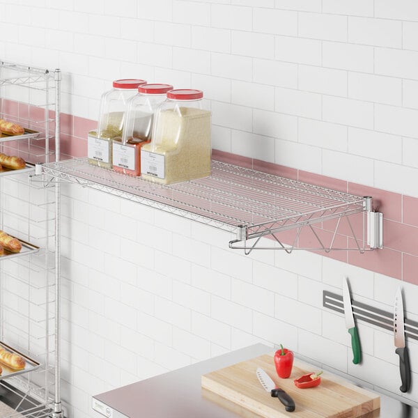 A Regency chrome wire wall mount shelf with food on it, including a container of rice.