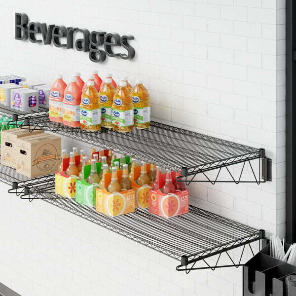 A Regency black wire wall mount shelf with beverages on it.