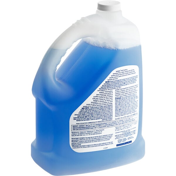 A blue liquid in a plastic jug with a white label.