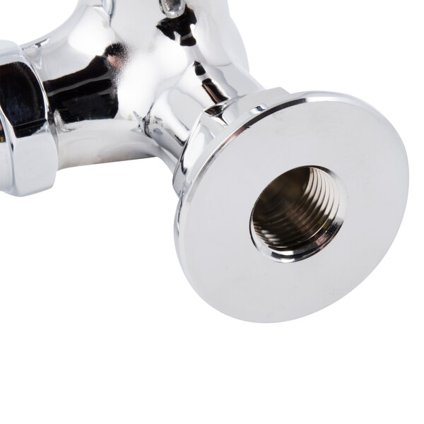 A close-up of a chrome T&S wall mounted single hole faucet with 4-arm handle.