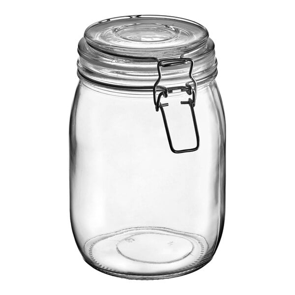 A clear glass storage jar with a hinge top and metal clasp closure.