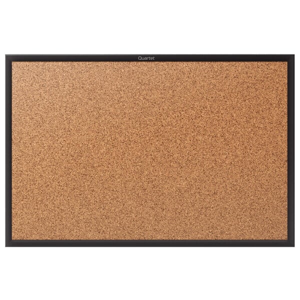 A Quartet cork board with black aluminum frame.