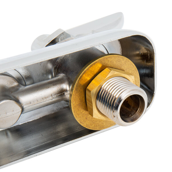 A close up of a T&S brass wall mounted faucet pipe with brass nut.