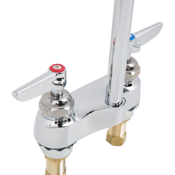 A T&amp;S chrome deck-mounted faucet with lever handles.