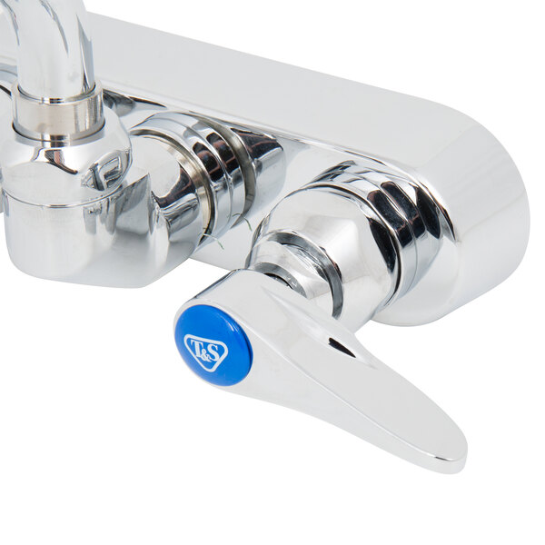 A chrome T&S wall mount faucet with blue lever handles.