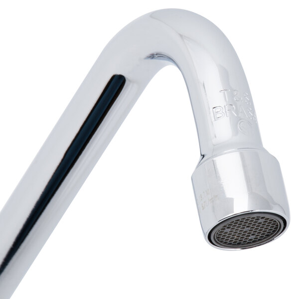 A close-up of a T&S chrome deck-mounted faucet with lever handles.