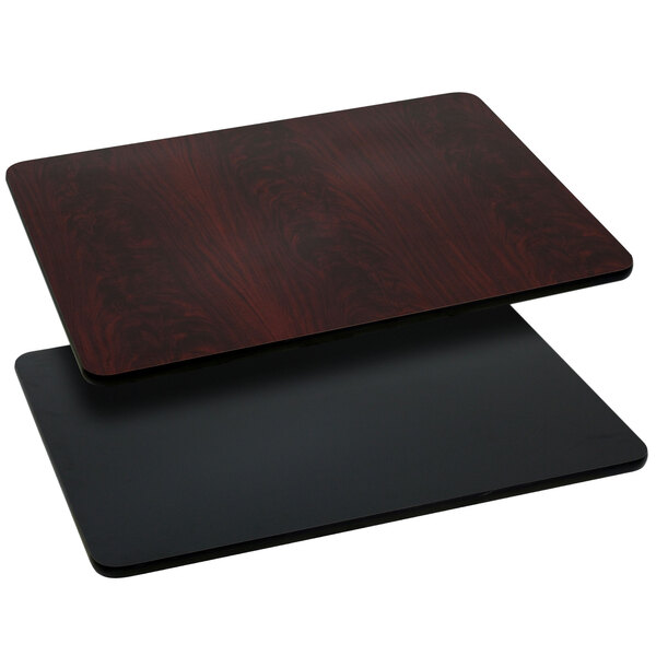 A close-up of a black and mahogany Flash Furniture rectangular table top.