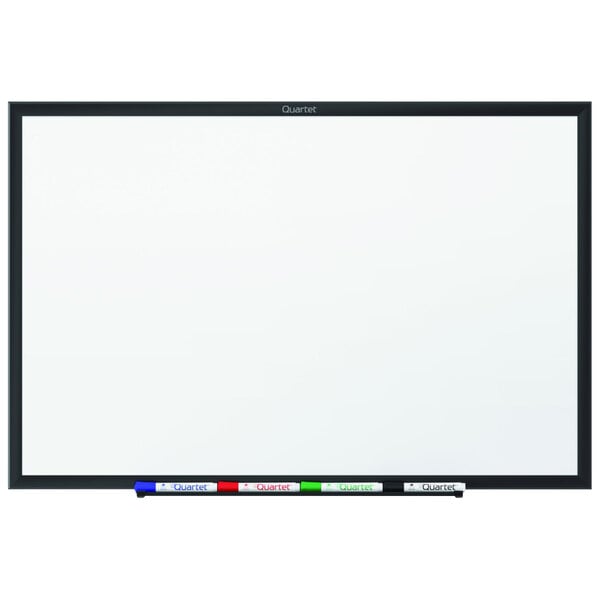 A Quartet melamine whiteboard with a black frame.