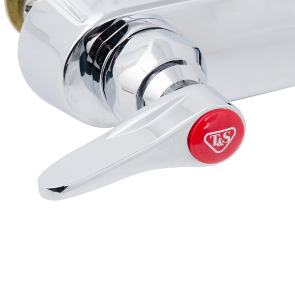 A chrome T&S wall mount faucet with lever handles and a red button on the side.