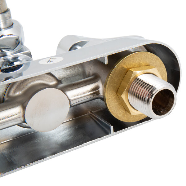 A close up of a T&S wall mounted faucet with metal pipes and brass fittings.