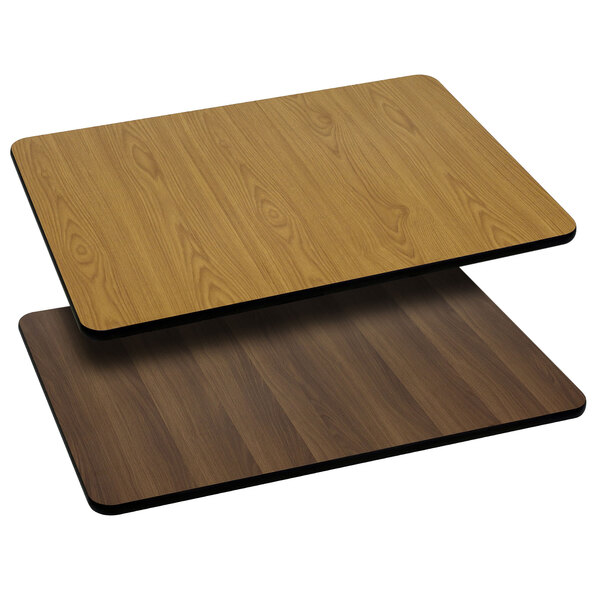 A Flash Furniture rectangular table top with natural and walnut wood grain on a table.