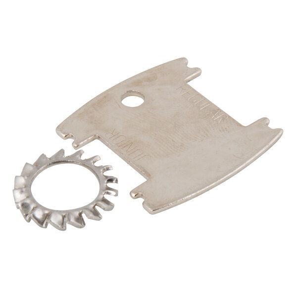 A close-up of a T&S wall mount faucet with silver metal and circular objects on the handles.