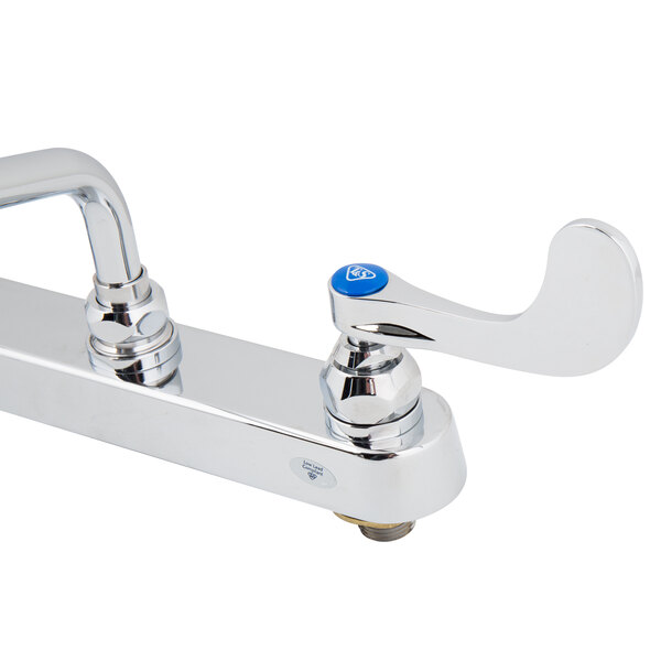 A white T&S deck-mounted workboard faucet with blue wrist handles.