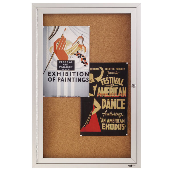 A Quartet cork board cabinet with posters on it.