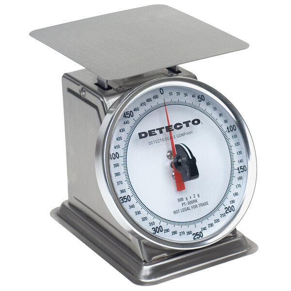 A close-up of a stainless steel Cardinal Detecto portion scale with a rotating dial.