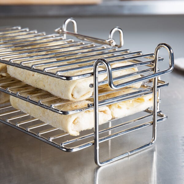 A Tablecraft burrito fryer basket with food on a rack.
