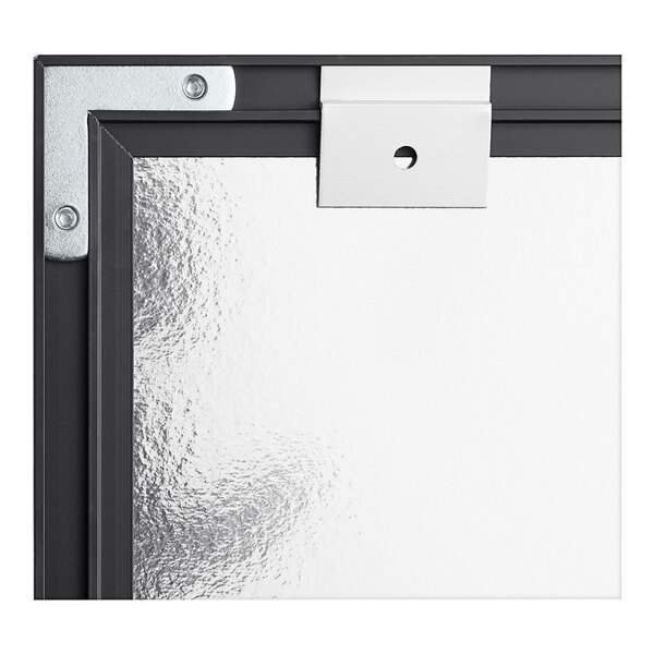 A close up of the black aluminum frame on a Quartet whiteboard.